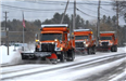 3 snow plows clearing the road