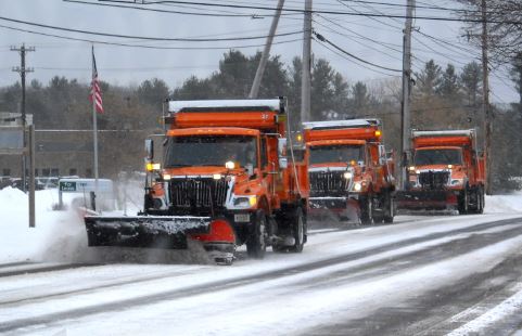 3 snow plows clearing the road